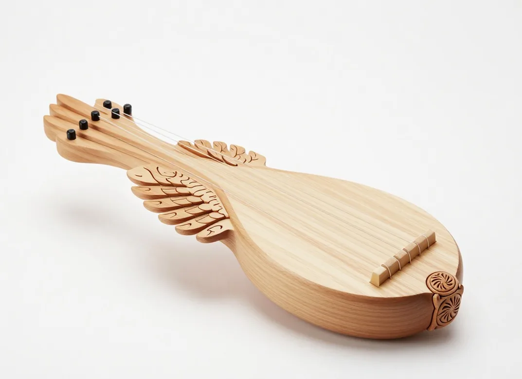 Handcrafted nine string wing shaped gusli made of light maple with spruce soundboard
